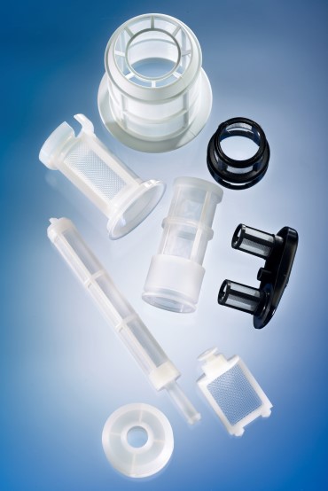 A selection of black and white overmoulded plastic filters, cylindrical in shape, on a blue background